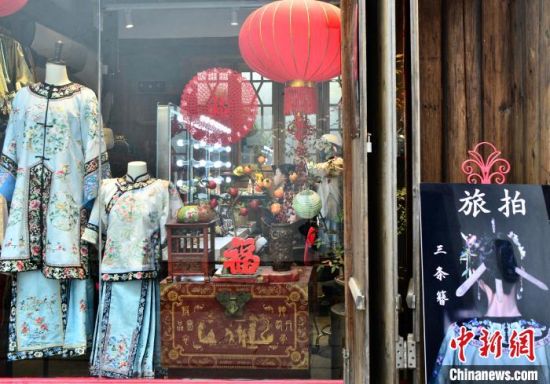 图为5月5日，在福州三坊七巷一处“三条簪”旅拍店，化妆师在为游客进行“三条簪”妆造。中新社记者 张斌 摄